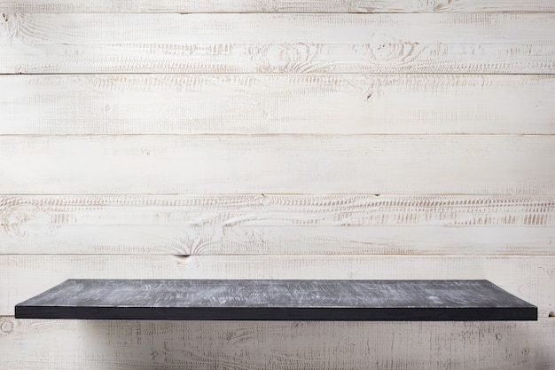 Shelf at white plank wooden background texture