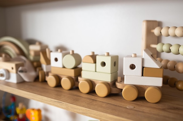 A shelf with children's wooden toys in the children's room Children's concept