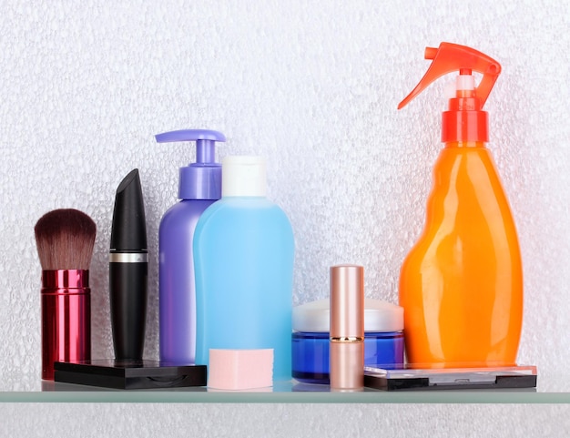 Shelf with cosmetics and toiletries in bathroom