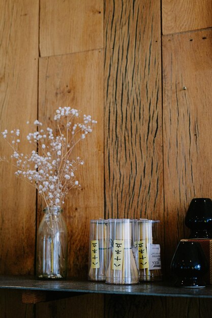 A shelf with jars and flowers on it Stock Photo