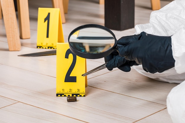 Photo a shell casing or bullet at a crime scene with evidence markers