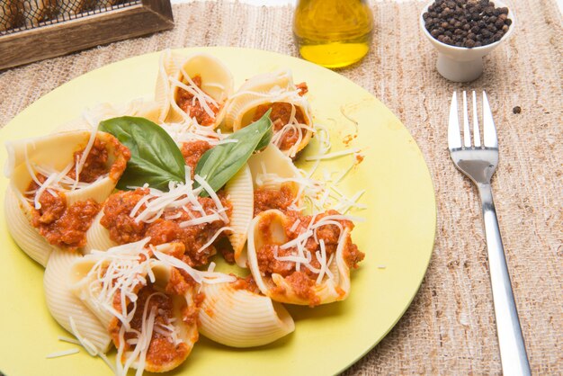 shell type pasta dish with meat served on table