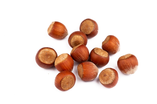 Shelled hazelnuts on the white background