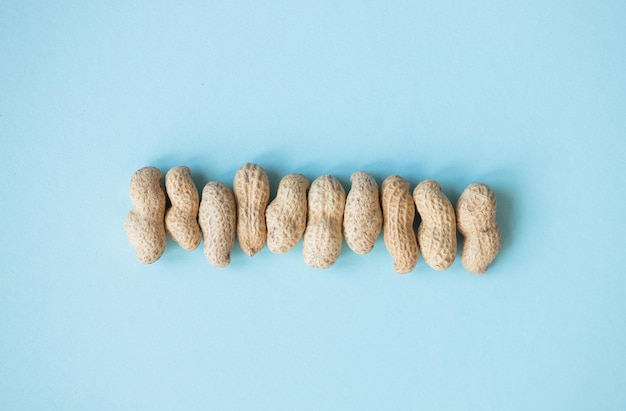 Shelled peanuts on blue background