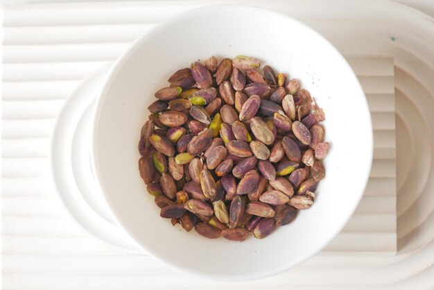 Shelled pistachio in a bowl on table