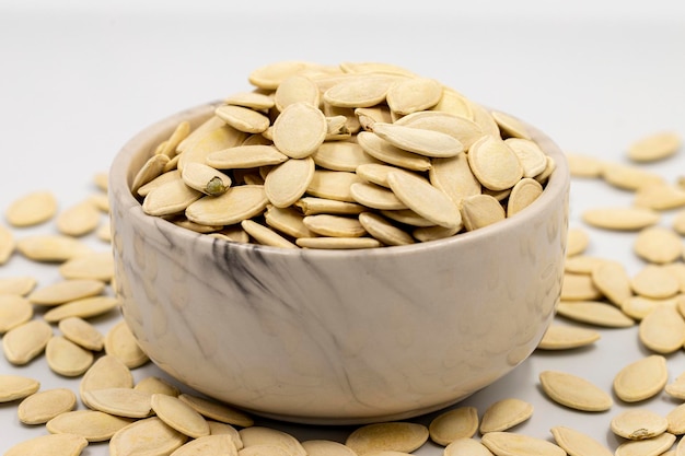 Shelled pumpkin seeds on a white background Closeup local name kabak cekirdegi