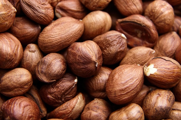 Shelled raw hazelnuts background closeup