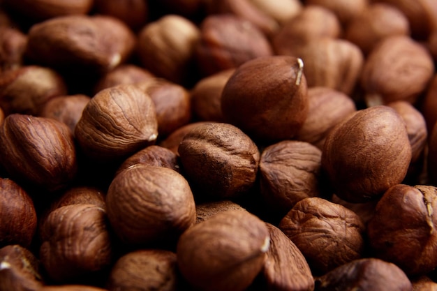 Shelled raw hazelnuts background closeup