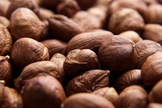 Shelled raw hazelnuts background closeup