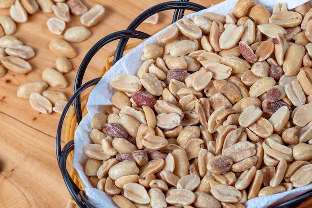 Shelled and roasted peanuts in a small basket