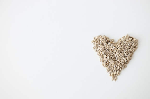 Shelled sunflower seeds over white background