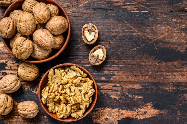 Shelled walnuts on wooden table.