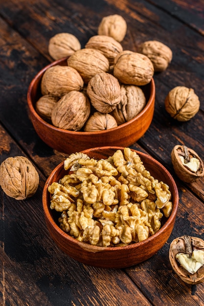 Shelled walnuts on wooden table.