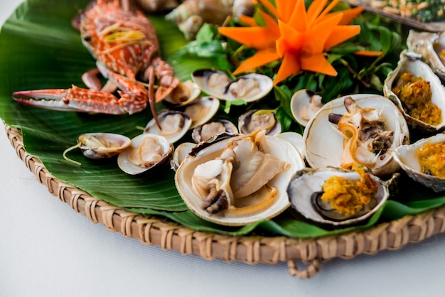 Shells on the dish with the palm leaf.