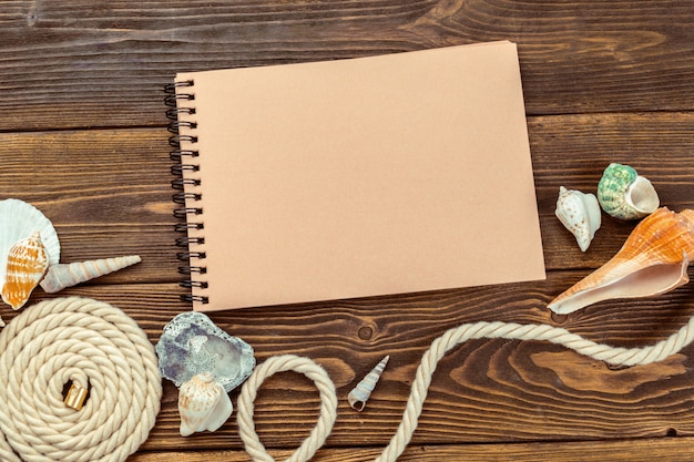 Shells and notepad on wooden table