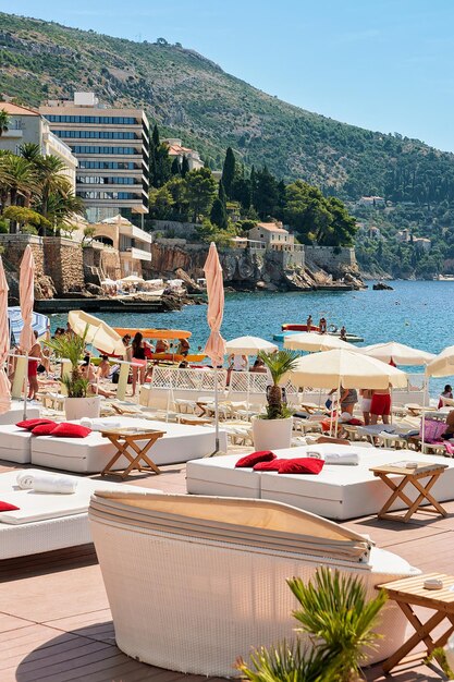 Shelters at beach at Adriatic Sea Dubrovnik, Croatia. People on the background