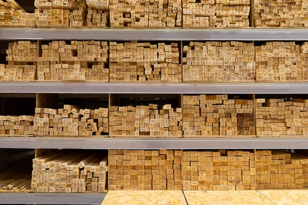 Shelves of a hardware store lined with stacks of wooden boards.