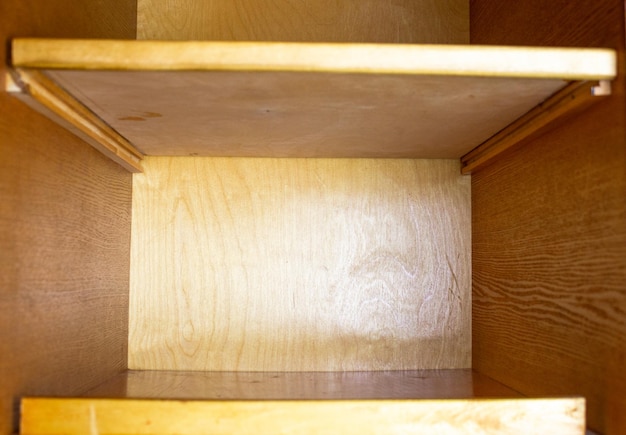 Shelves of an old wooden cabinet wooden cabinet with empty\
shelves wooden cabinet inside