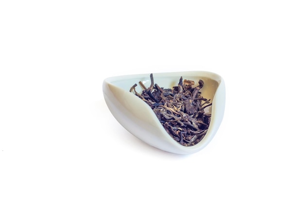 Shen PU'er in a white bowl cha he loose Yunnan Bai Cha isolated on a white