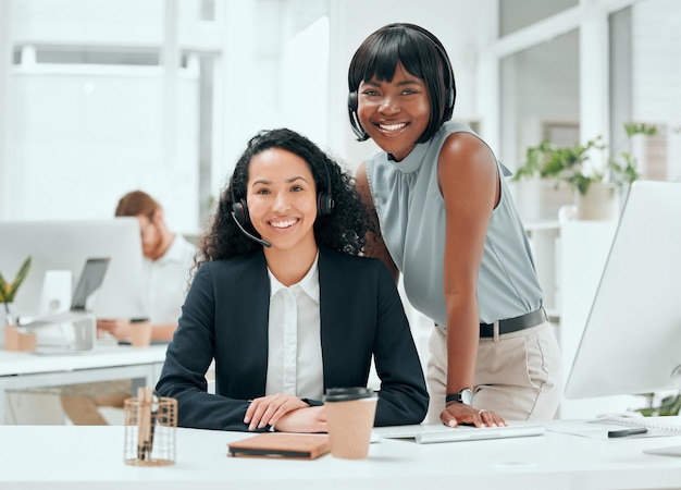 Photo shes going to go far in this industry cropped portrait of an attractive young female call center agent and her supervisor working in the office