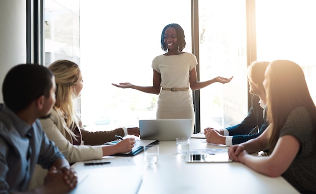 Shes got their full attention Shot of a young businesswoman leading her team in a meeting in the office