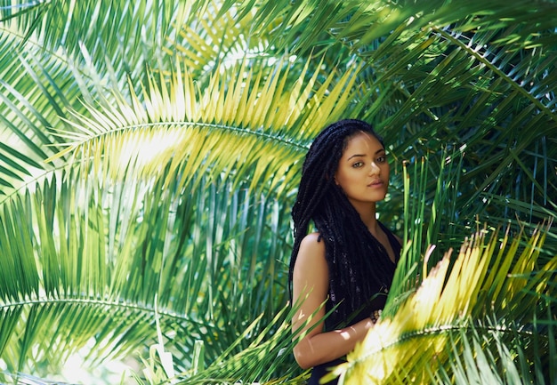 Shes a hidden flower amongst the ferns Portrait of an attractive young woman posing against a leafy background