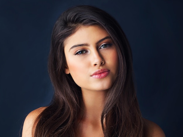 Shes the picture of beauty Cropped portrait of a gorgeous young woman posing against a dark background