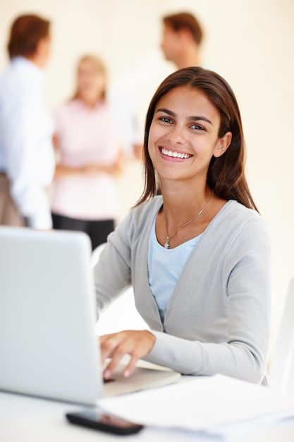 Shes positive its going to get done Shot of an attractive young woman using a laptop in a brightly lit office