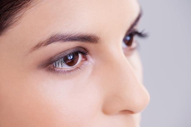 Shes a sight for sore eyes Studio shot of a beautiful brunette woman against a gray background