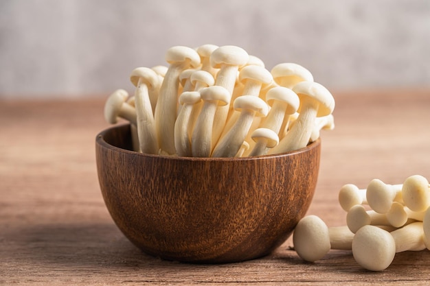 Shimeji Fresh white bunapi mushrooms from Asia in wooden bowl