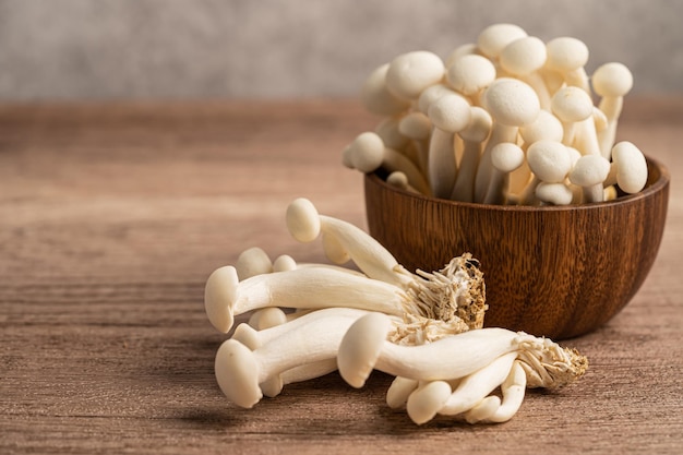 Shimeji Fresh white bunapi mushrooms from Asia in wooden bowl