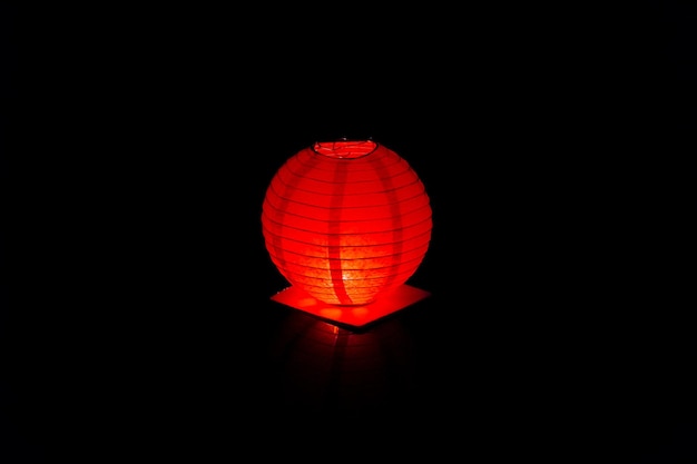 A shining red water lantern in the night