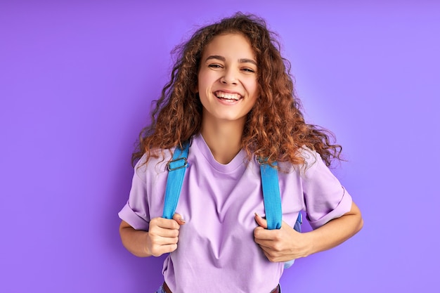 Shining with happiness student girl isolated on purple space, love studying and education