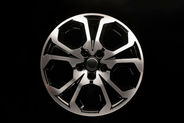 Shiny alloy wheels new design in the shape of a star, front view, on a black background.