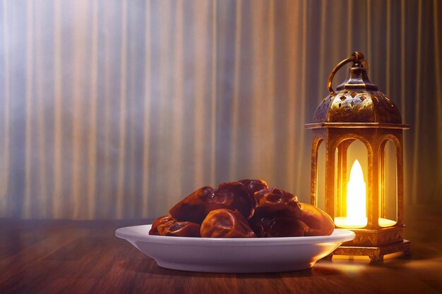 Shiny arabic lantern and bowl of fresh dried dates on wooden floor with golden curtain