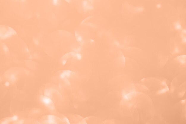 Shiny background texture with bokeh Color of the year 2024 Peach fuzz