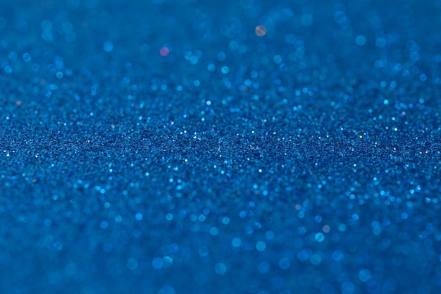 Shiny blue background with blur photo with depth of field in the middle metallic shimmers paper