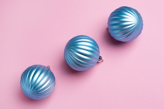 Shiny blue balls on a pink background for Christmas decorations