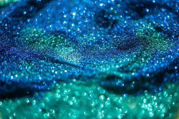 Shiny blue green glitter textured background