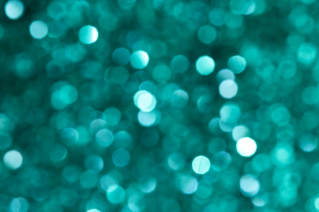 Shiny blurry green glitter textured background