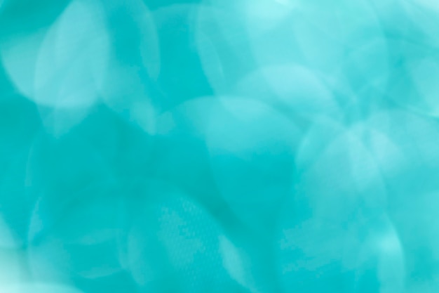 Shiny blurry turquoise glitter textured background