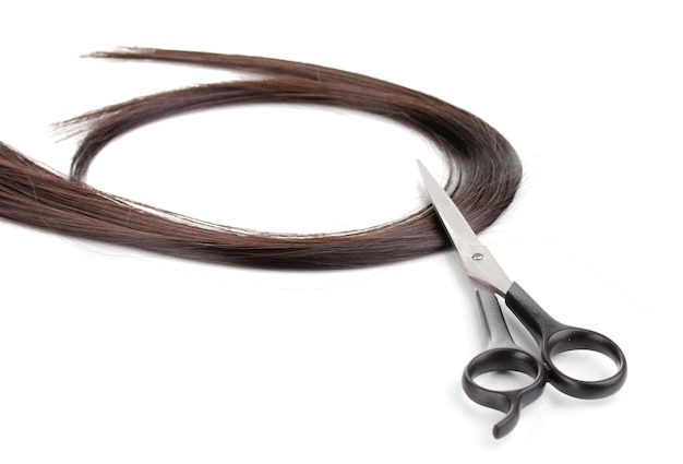 Shiny brown hair and hair cutting shears isolated on white