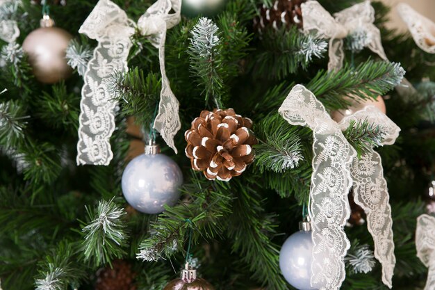 Shiny Christmas balls hanging on pine branches