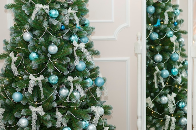 Shiny Christmas balls hanging on pine branches