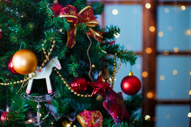 Shiny Christmas red ball hanging on pine branches with festive background