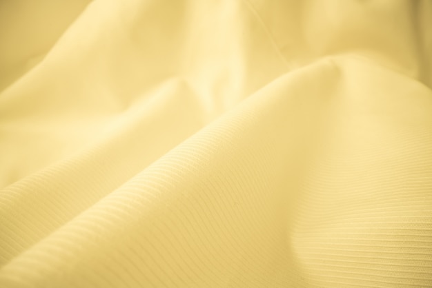 Shiny flowing cloth texture in macro shot. Wavy clean silk weave material. Textile abstract background.