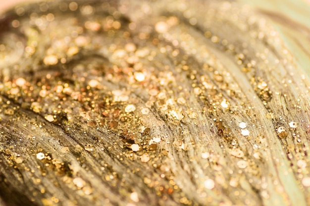 Shiny gold glittering background with soft selective focus