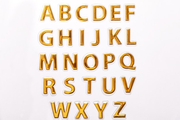 Photo shiny golden letters isolated on white