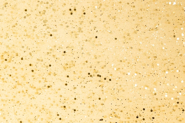 Shiny golden yellow background with bright rhinestones