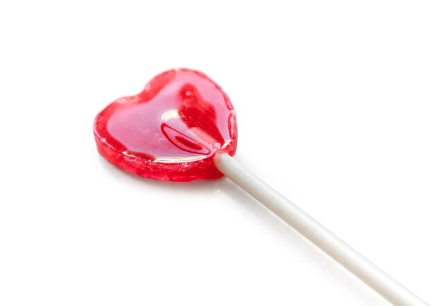 Photo shiny red heart shaped lollipop isolated on white background